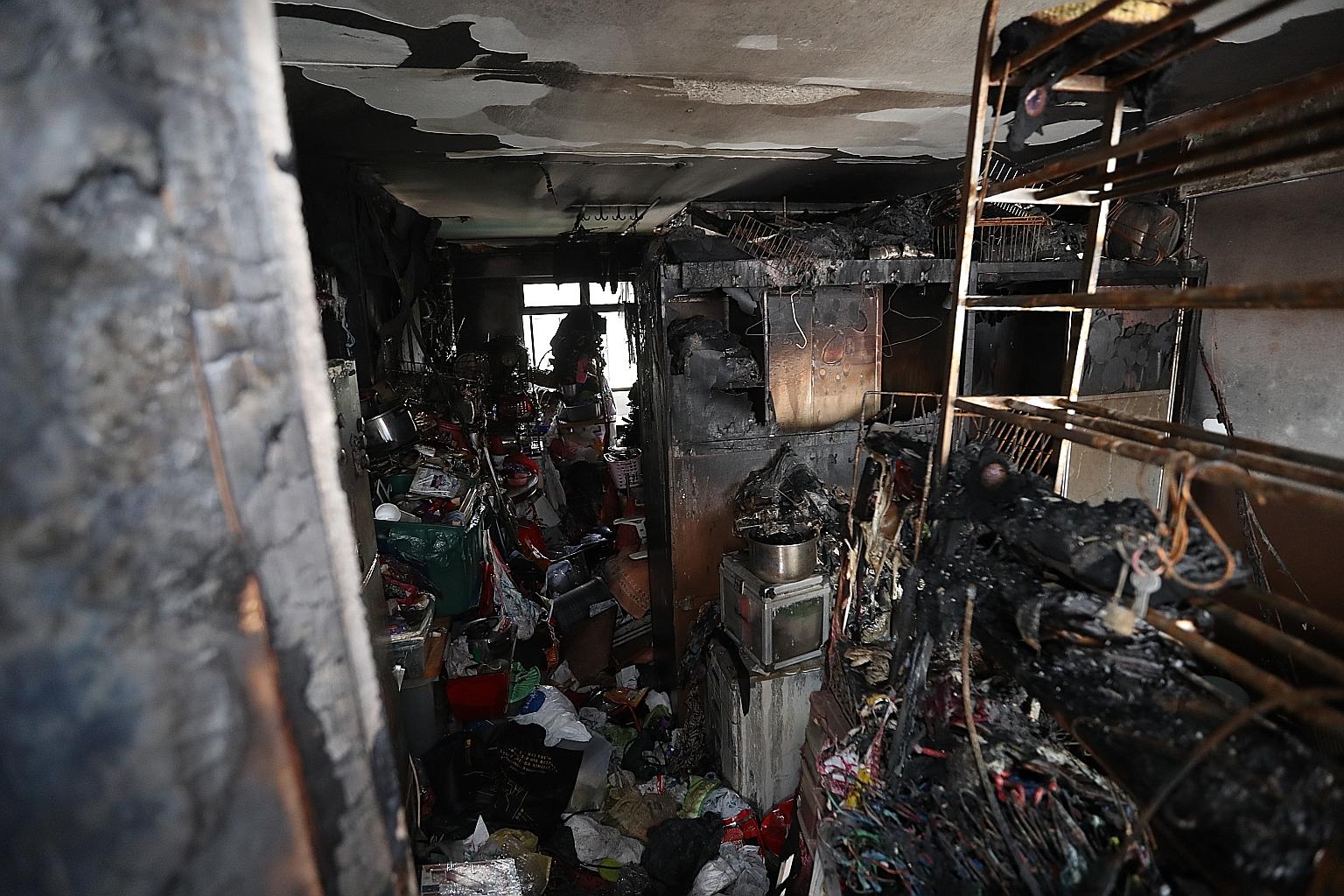 The charred remains of the family's belongings in the Bukit Batok flat after a fire broke out on Nov 1. The woman's husband and son were also hospitalised for burn injuries and smoke inhalation but have been discharged.