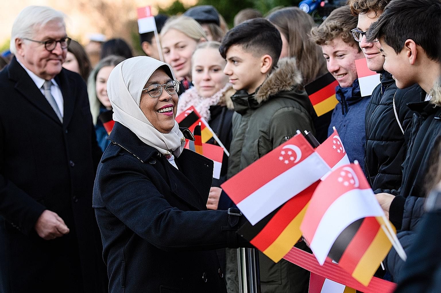 President Halimah Yacob meeting students from Berlin's Walther-Rathenau Gymnasium yesterday following a welcome ceremony at Schloss Bellevue, the official residence of German President Frank-Walter Steinmeier (far left). Both heads of state reaffirme