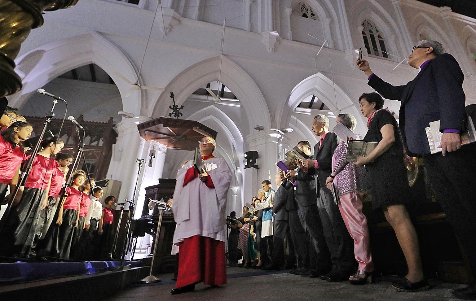 Dr Peter Low (middle), director of the Cathedral Choir of the Risen Christ, led the Singapore Combined Church Choir during the service at St Andrew's Cathedral yesterday. Among those who attended were Prime Minister Lee Hsien Loong and Mrs Lee, as we