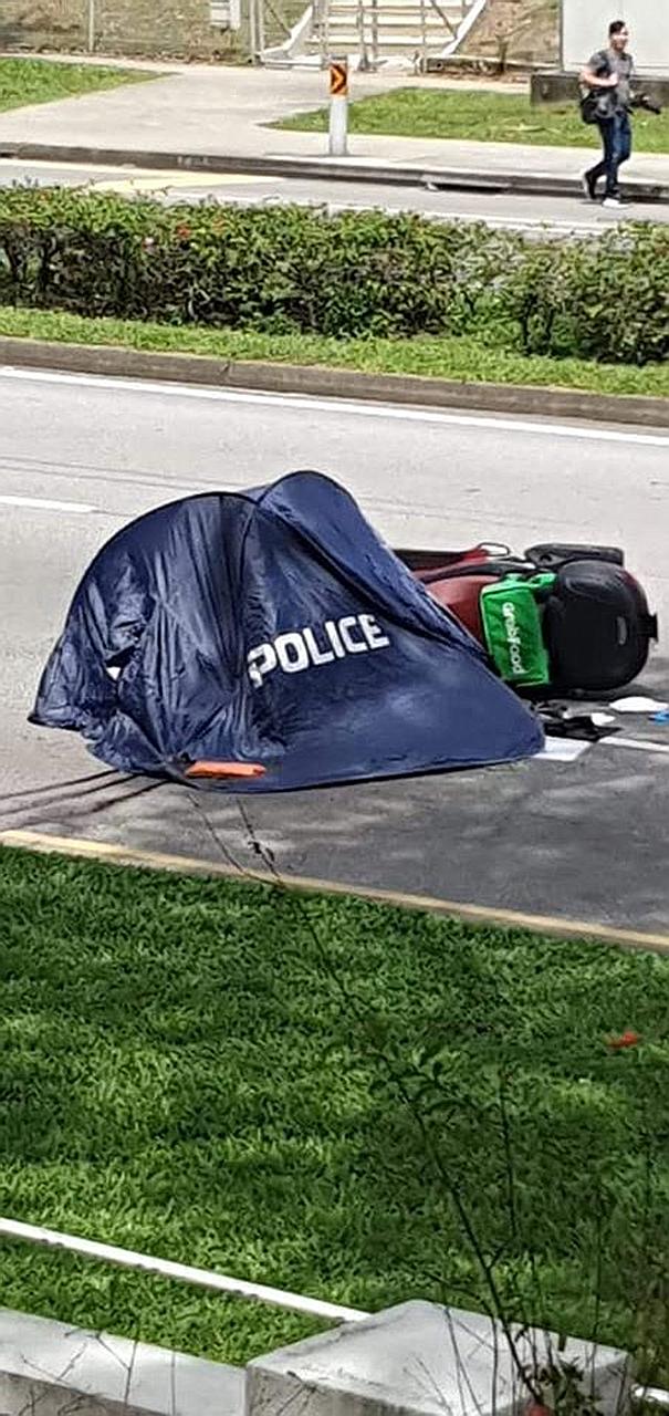 The scene of the accident in Gambas Avenue in the direction of Woodlands Avenue 8 yesterday. The delivery rider was pronounced dead at the scene by paramedics. PHOTO: SG ROAD VIGILANTE/ FACEBOOK