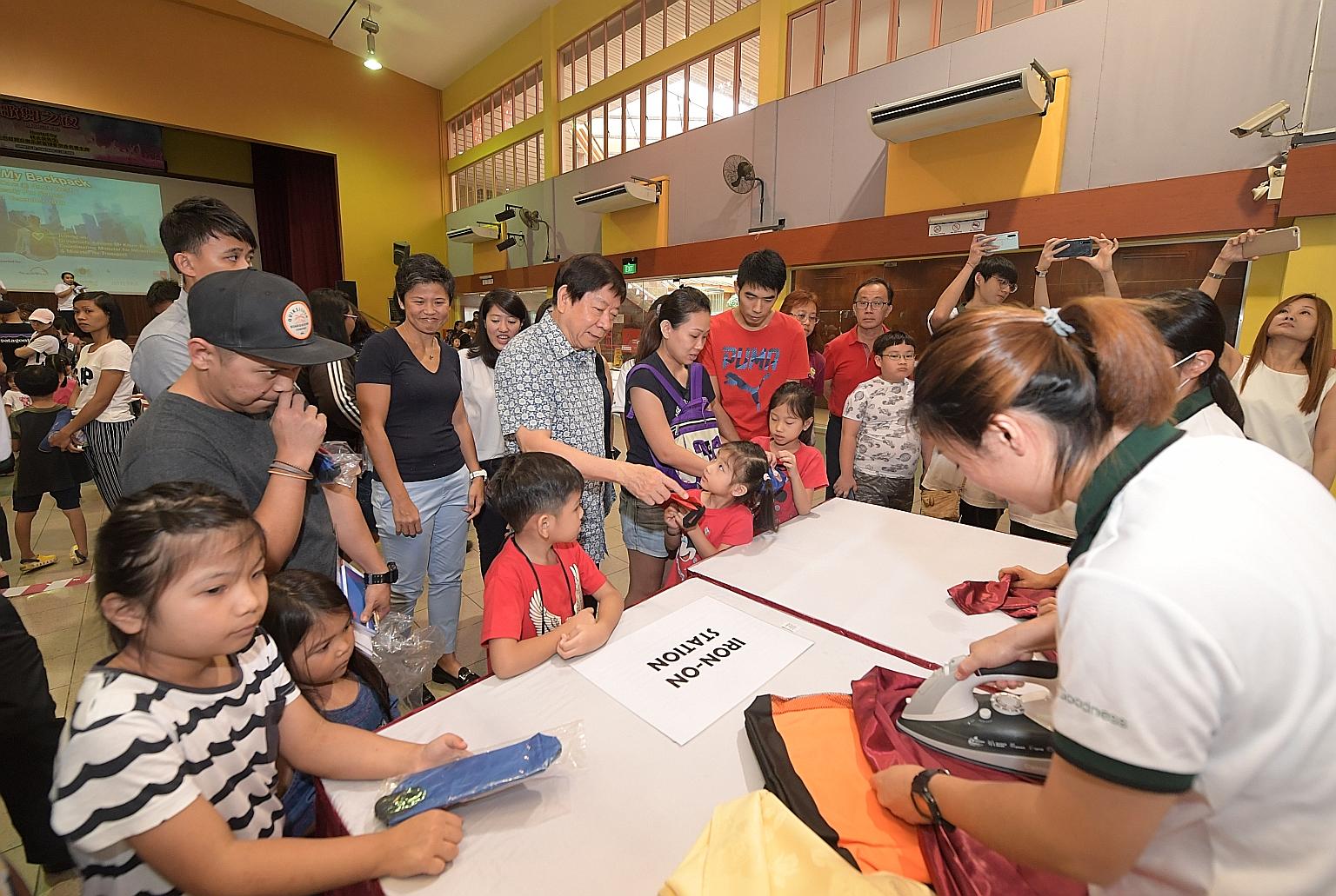 Coordinating Minister for Infrastructure and Minister for Transport Khaw Boon Wan, grassroots adviser of Sembawang GRC, attending the WeCare @ North West - Ready For School programme yesterday. About 300 students received new school bags, stationery