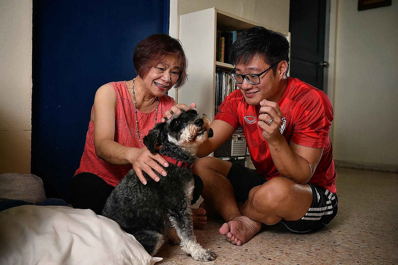 Assistant Superintendent of Police Jason Yeo and his mother, Madam Kristine Leong, with their five-year-old dog Keebles. Spending time with Keebles has brought mother and son closer together, helping to repair the relationship that was strained when 