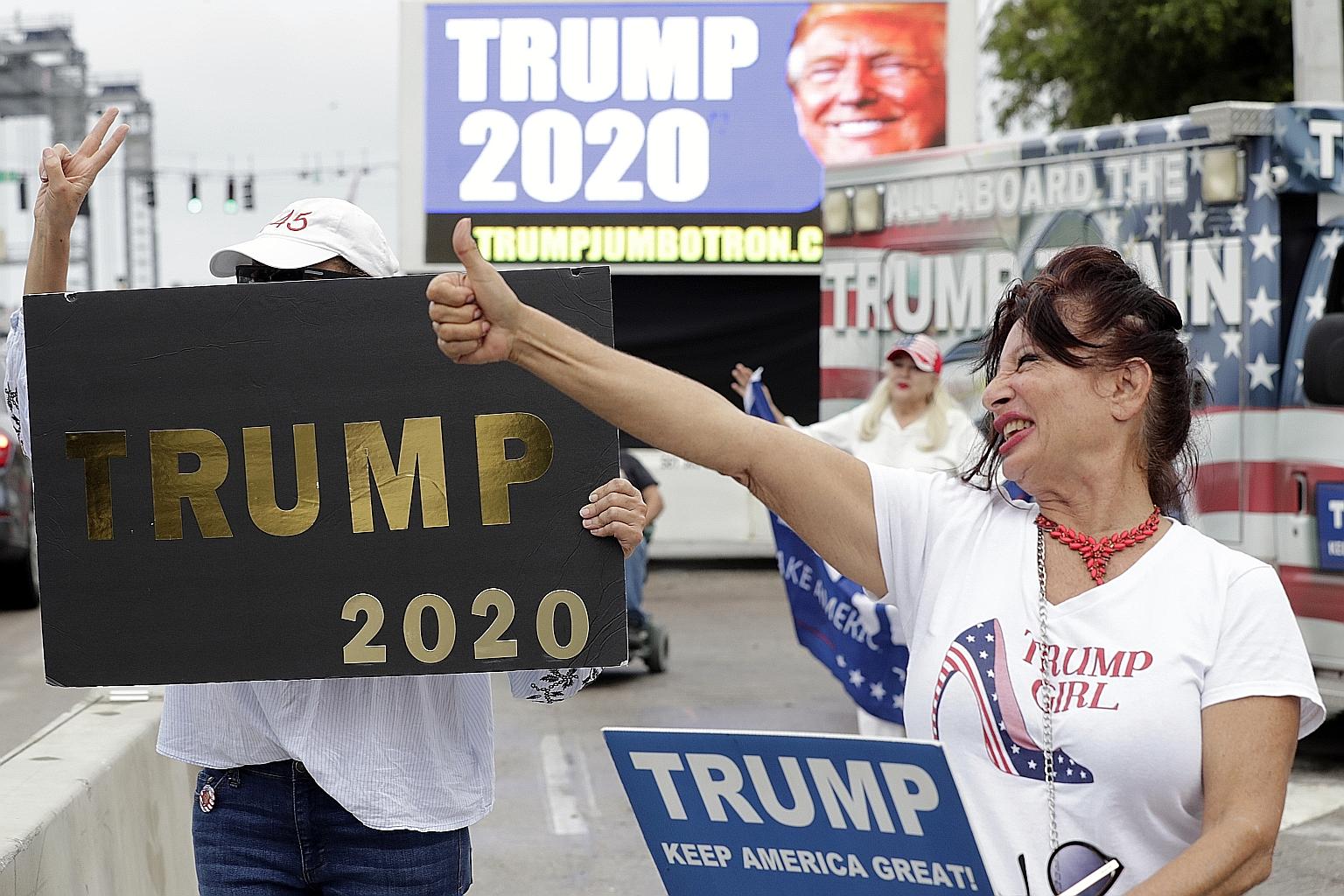 A supporter giving the thumbs-up while waiting for the motorcade carrying President Donald Trump to Mar-a-Largo, Florida, on Monday. Mr Trump is riding high in the polls, with supporters of the view that he has delivered on a host of high-profile iss