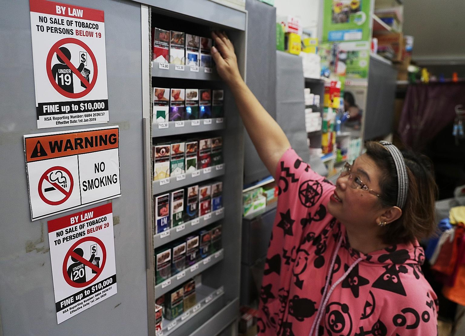Madam Sherley Ang, 54, owner of Hianky Provision Store, which displays both the new and old notices on the minimum legal age for purchasing tobacco. ST PHOTO: KELVIN CHNG