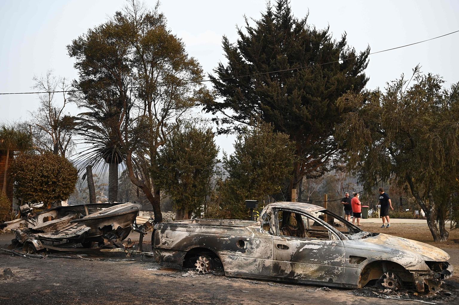 Vehicles gutted by bush fires in the town of Lake Conjola in New South Wales yesterday. Police said seven people have been killed in NSW this week, taking the confirmed national death toll since the blazes broke out weeks ago to at least 16. PHOTO: A