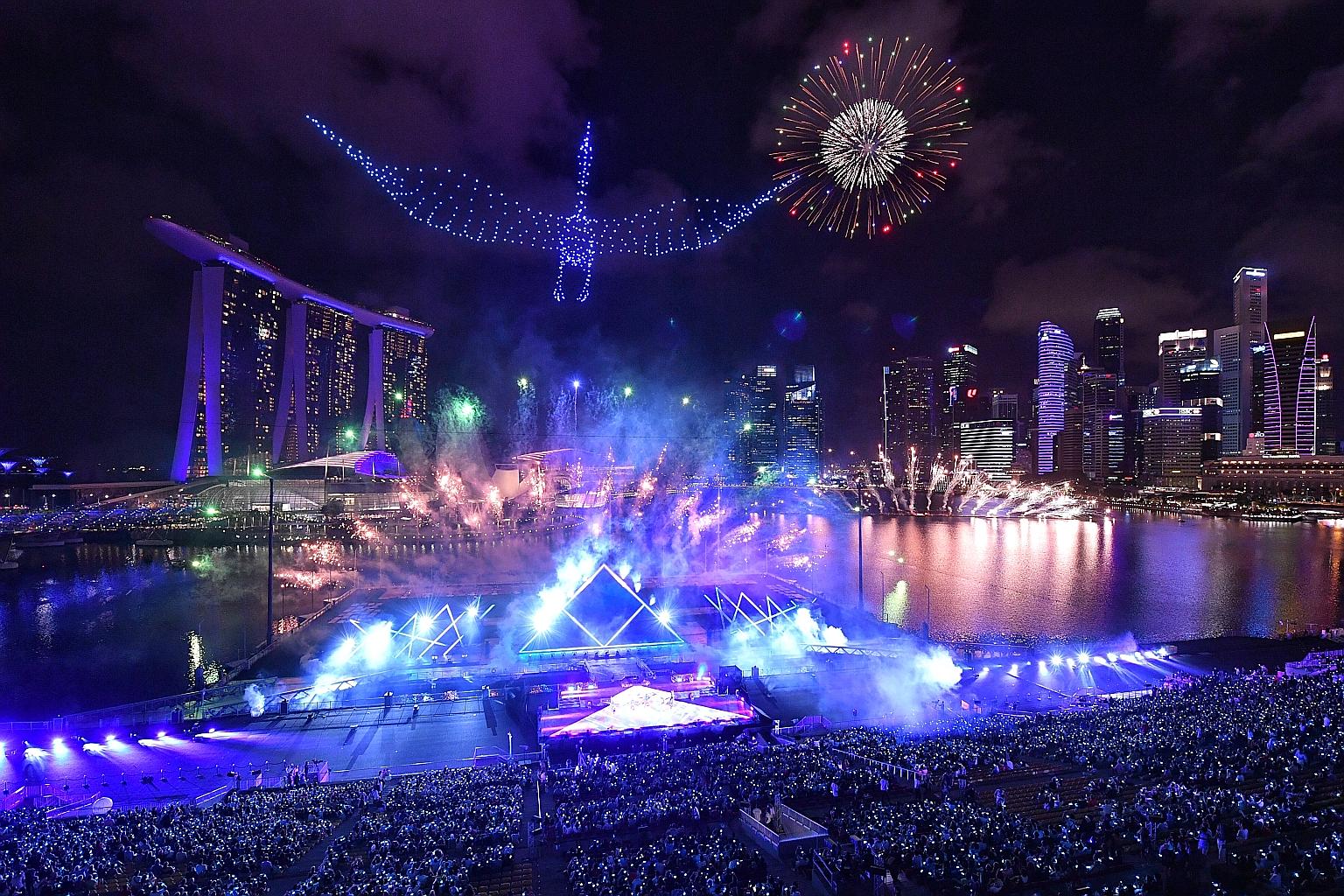 Drones forming the shape of a crane during the fireworks display at the Marina Bay countdown celebration. Revellers thronged the bay area from as early as 3pm on Tuesday to be part of the festivities. ST PHOTO: CHONG JUN LIANG
