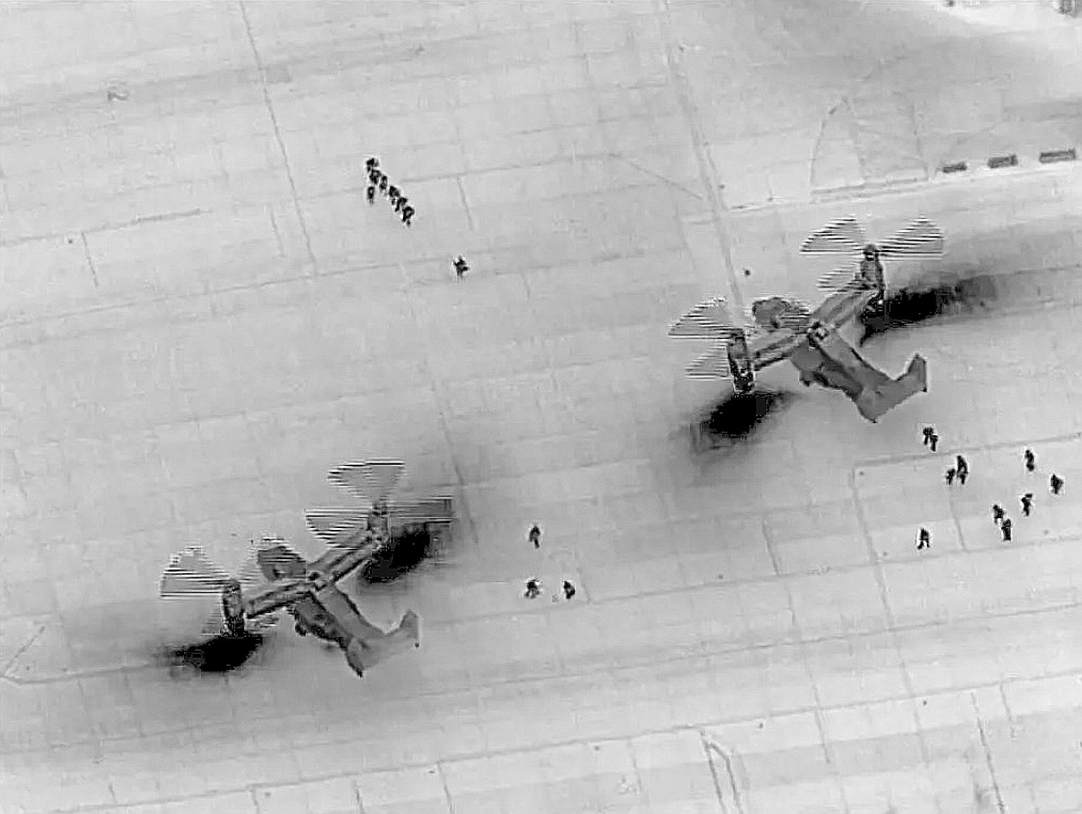 A handout photo from the US Defence Department showing US Marine Corps MV-22 Ospreys delivering crisis response forces inside the US embassy compound in Baghdad on Wednesday. Hashed supporters had stormed the high-security Green Zone and besieged the