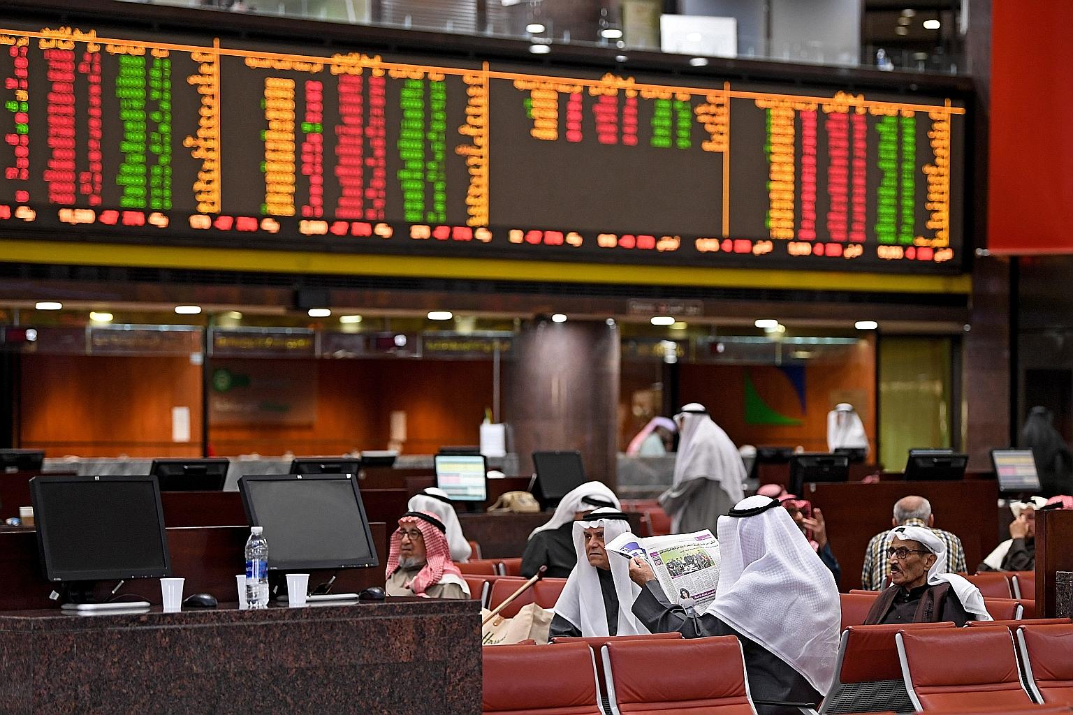 Traders observing stock market developments at the trading hall of the Kuwait Stock Exchange yesterday. The US air strike that killed Iranian commander Qassem Soleimani in Baghdad has injected new uncertainties into the market.