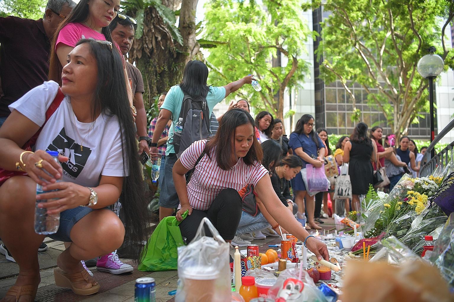 Mourners at a makeshift memorial near the site of the Dec 29 accident at Lucky Plaza on Sunday. ST PHOTO: ARIFFIN JAMAR