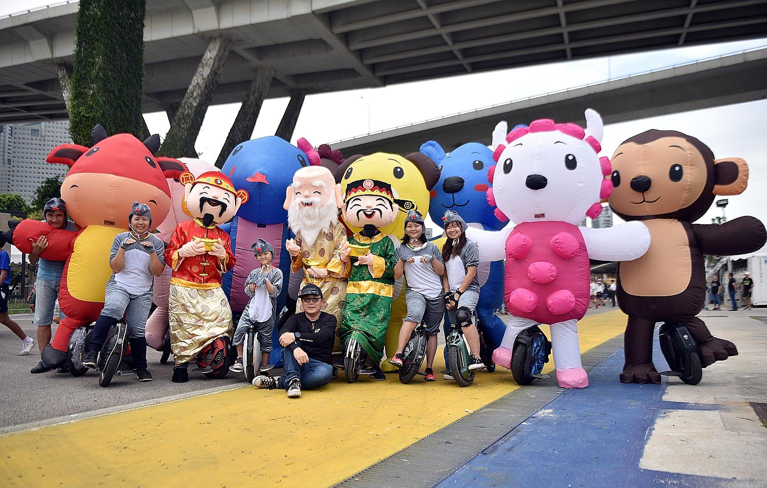 Members of the electric unicycle community, The Wheelies, decked out in some of the costumes they will be wearing at this year's Chingay parade. The 2m-tall inflatable costumes include the 12 animals of the Chinese horoscope and four deities - God of