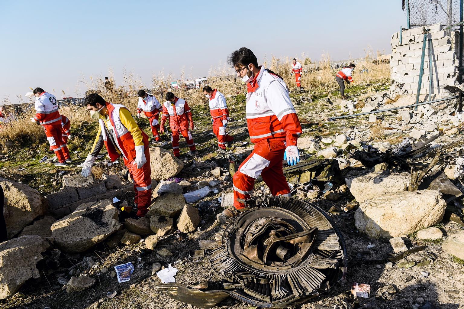 Rescue workers examining wreckage of the Boeing 737-800NG yesterday. The crash was Ukraine International Airlines' first fatal accident. Bodies of victims laid out at the site where the Ukraine International Airlines plane crashed after take-off from
