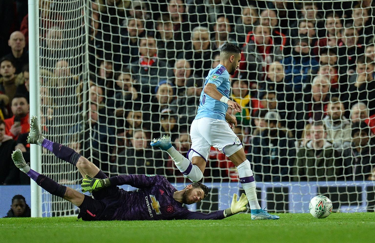 Manchester City's Riyad Mahrez beating Man United goalkeeper David de Gea to score his sixth goal in 19 starts in all competitions this season during the first leg of their League Cup semi-final clash on Tuesday. City won 3-1. PHOTO: EPA-EFE