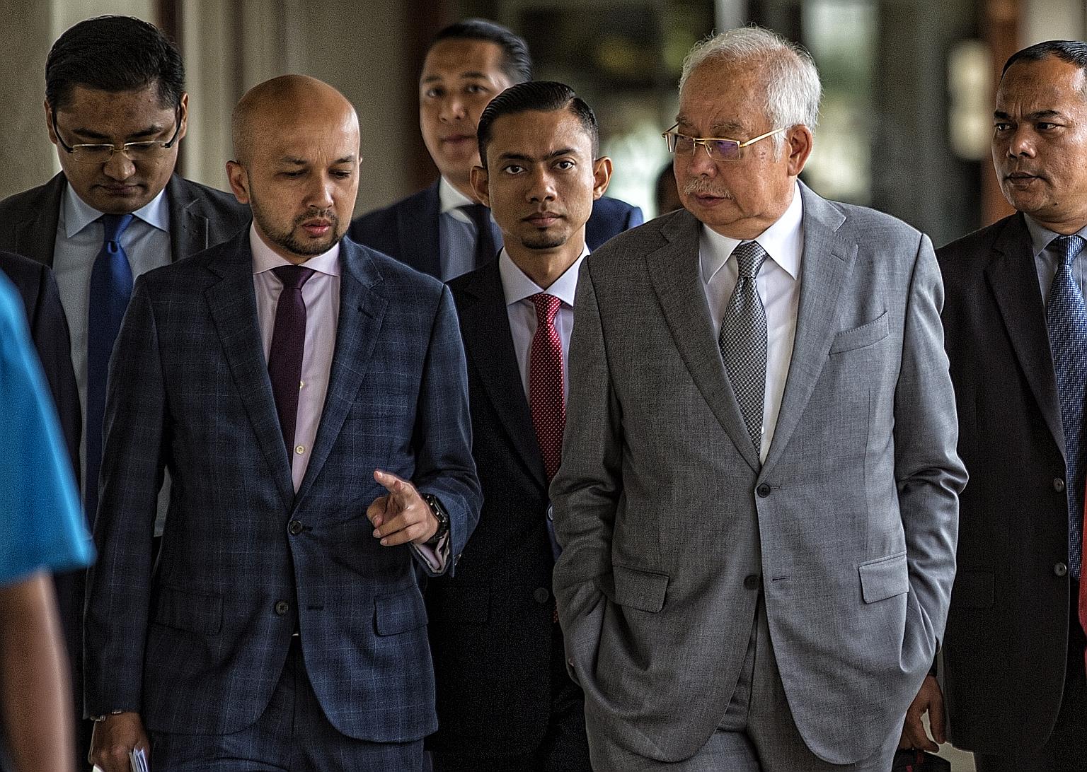 Former Malaysian premier Najib Razak (right) at the Kuala Lumpur courthouse yesterday. He said he was "shocked" over the airing of the clips and had referred the matter to his lawyer. His wife Rosmah Mansor did not deny or confirm whether the recordi