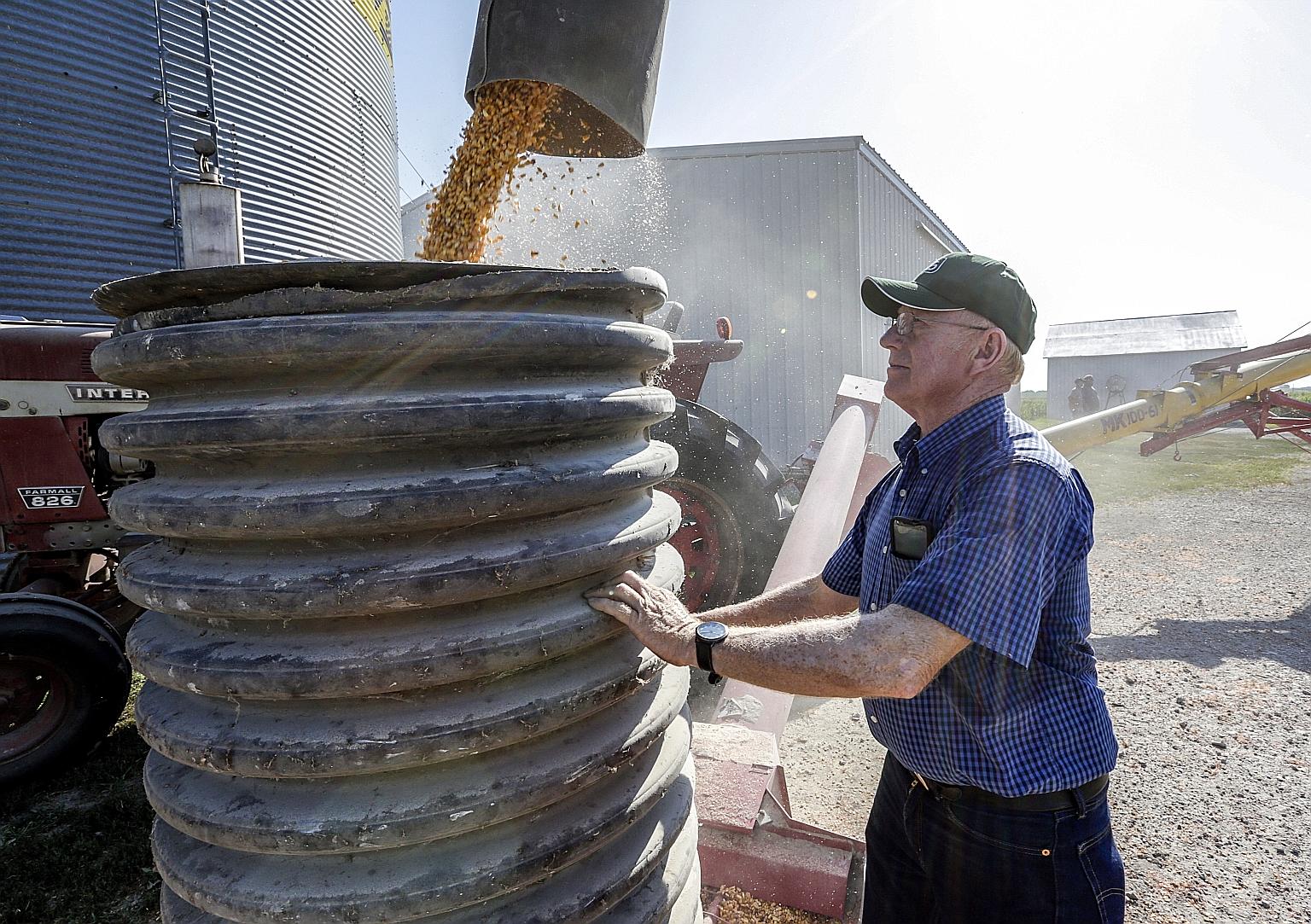 US farmer Don Bloss checking on the operation of an auger transferring corn on his farm in Pawnee City, Nebraska, in this 2018 file photo. Trade tensions between the United States and China cooled with the announcement of a so-called phase one trade 