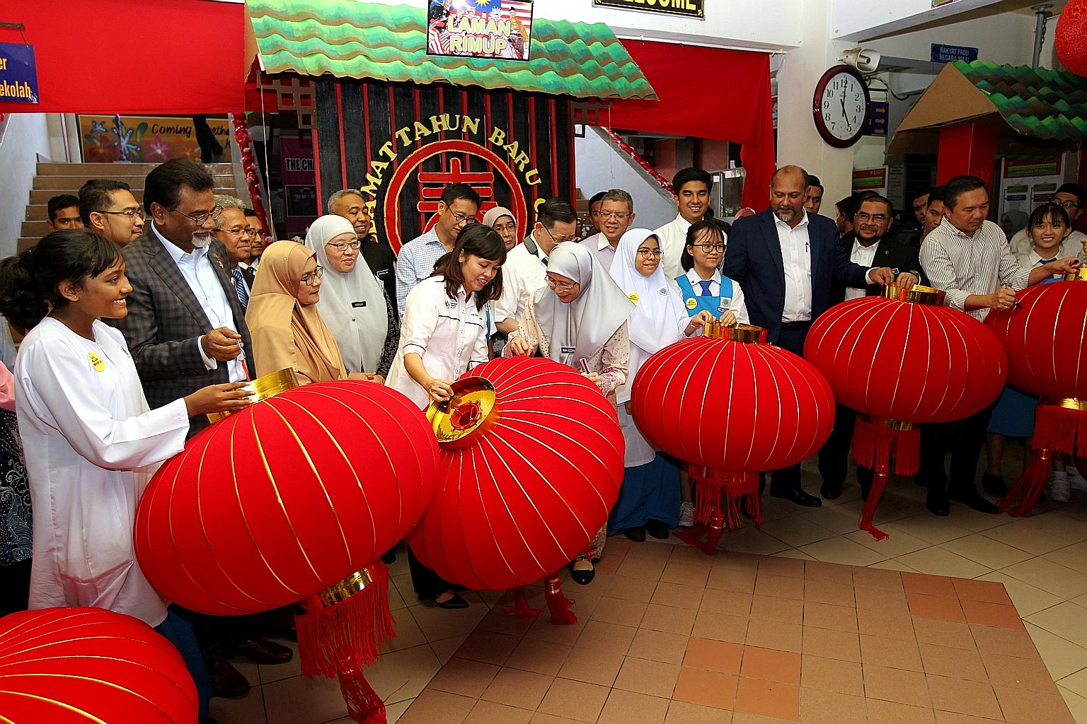Deputy Prime Minister Wan Azizah Wan Ismail and Deputy Education Minister Teo Nie Ching (both centre) were among ministers who turned up yesterday at SMK Pusat Bandar Puchong 1 in Selangor to help put up lanterns for Chinese New Year. The school had