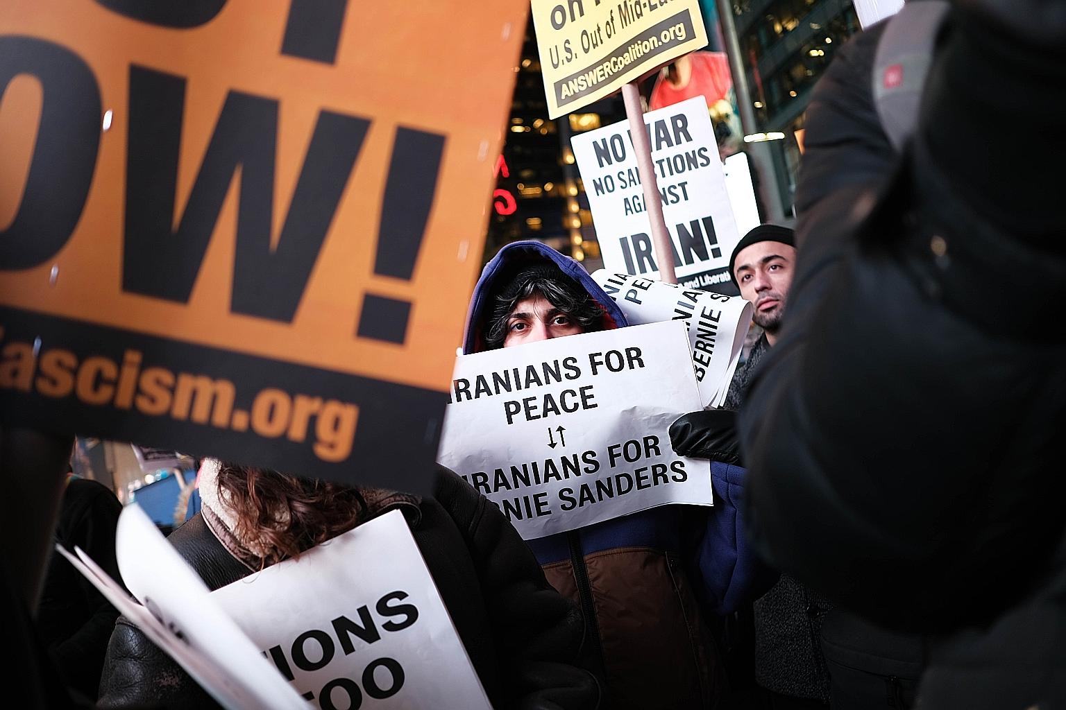 Demonstrators at a protest in Times Square against military conflict with Iran in New York City on Wednesday. President Donald Trump has vowed to impose more sanctions against Iran but also said "the United States is ready to embrace peace with all w