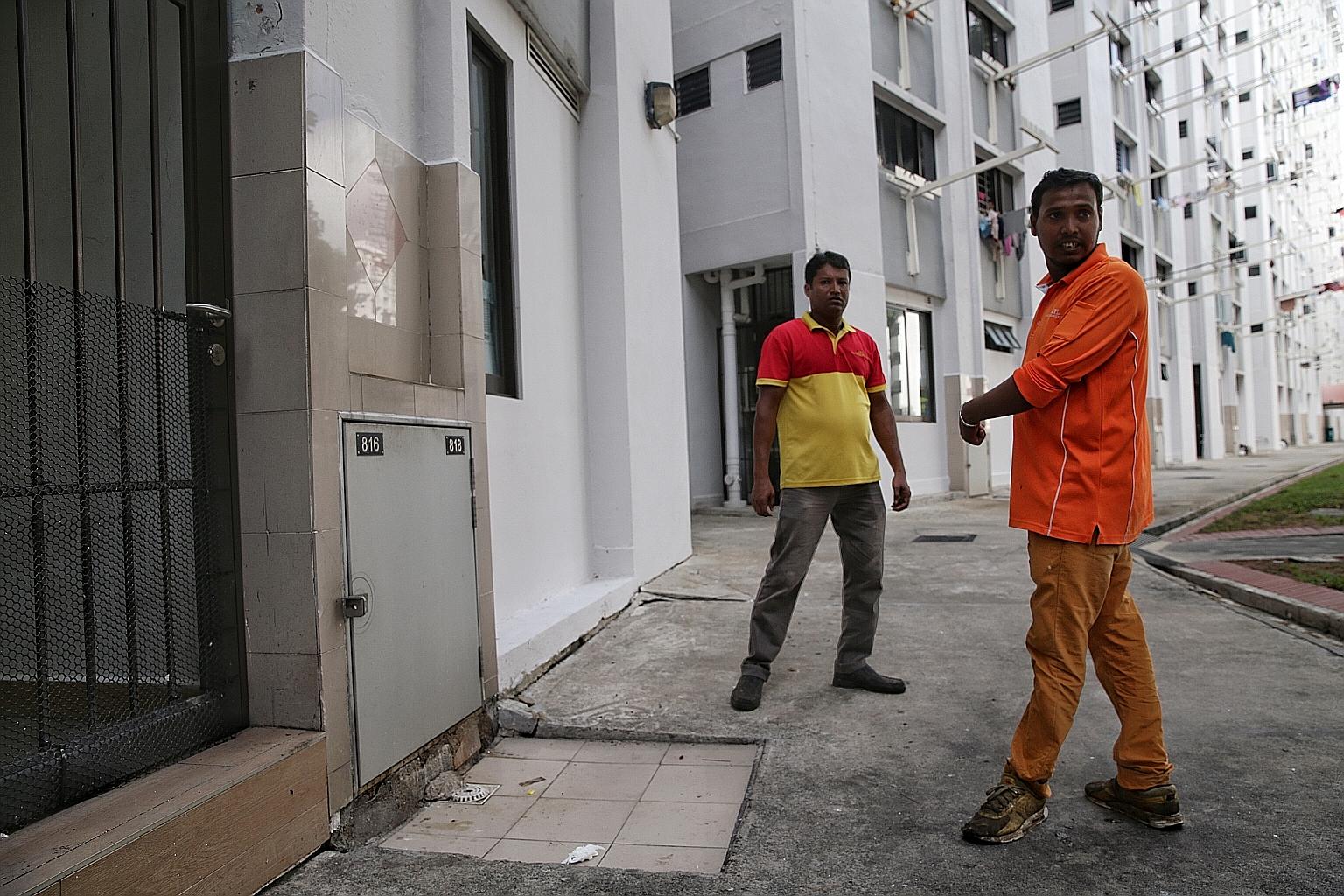 Bangladeshi cleaners Patwari Shamim (right) and Mostafa Kamal at the rubbish chute at Block 534 Bedok North Street 3, where the baby was found inside a plastic bag in the bin. The two men heard crying while they were on a buggy collecting rubbish, an