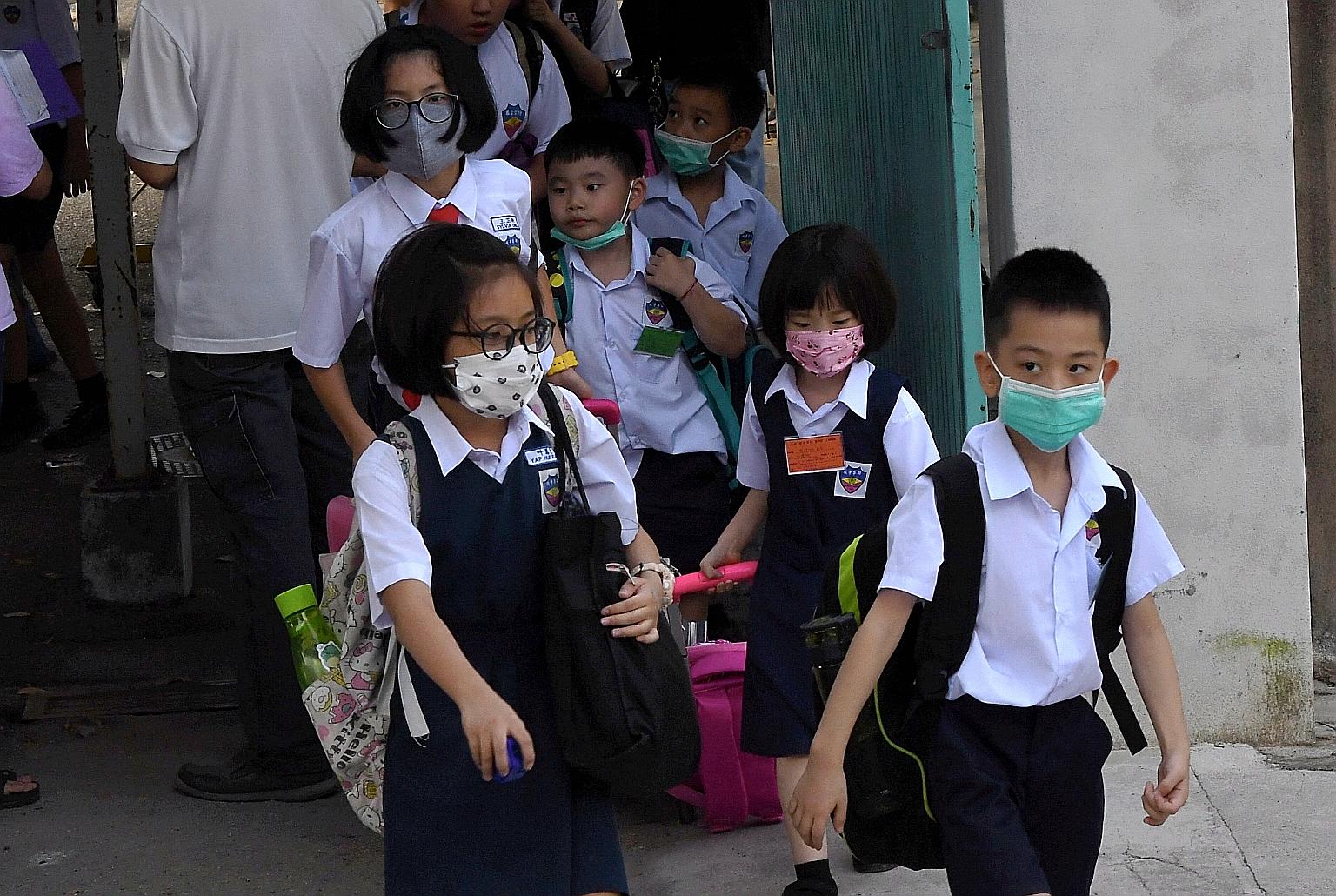 Pupils at the Chinese language school SJKC Li Hwa in Malaysia wearing face masks on Thursday. Nineteen pupils in two classes at the school came down with the flu on Thursday. PHOTO: BERNAMA