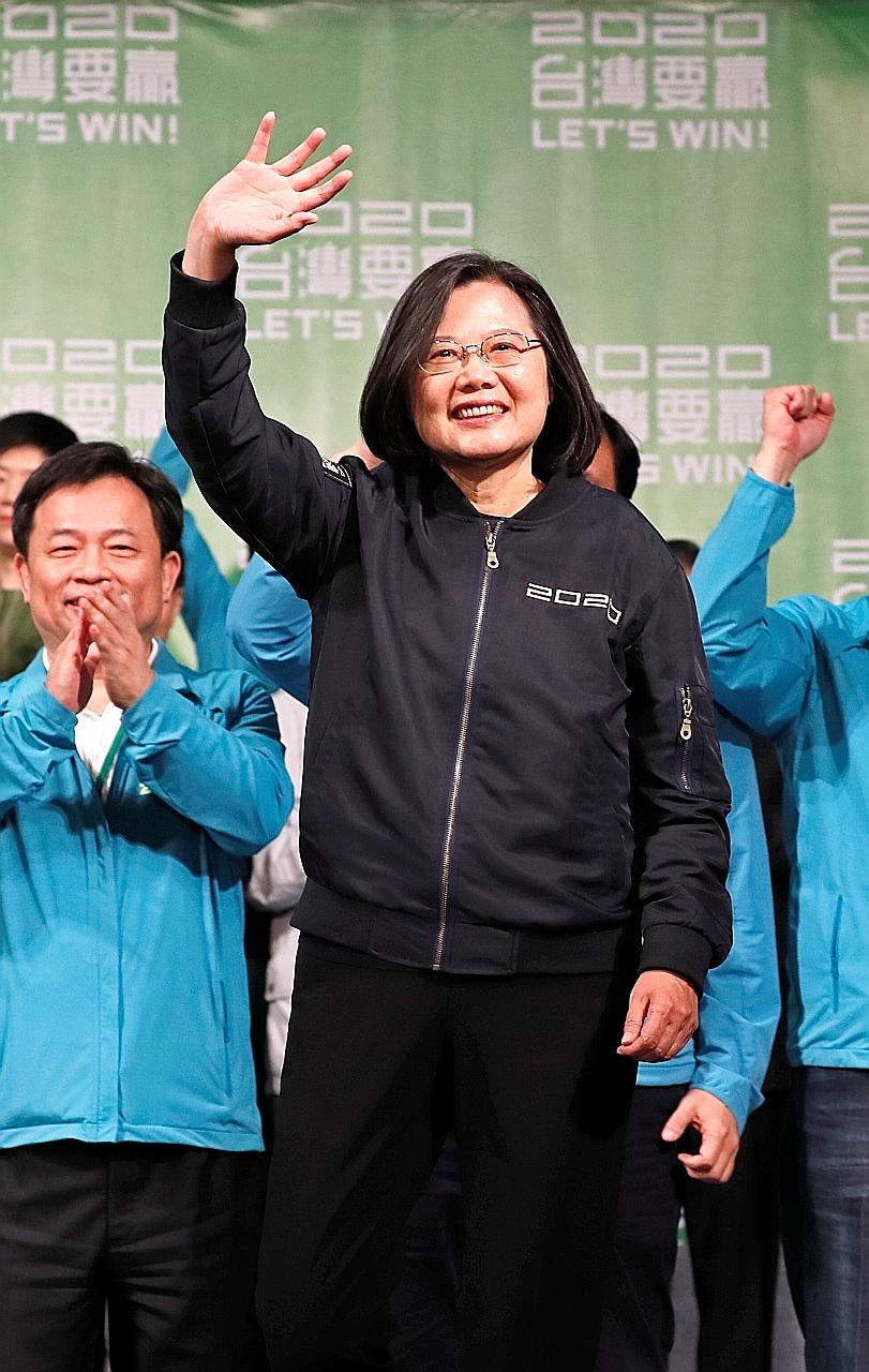 Taiwan's President Tsai Ing-wen, who won 57 per cent of the votes, acknowledging supporters outside the Democratic Progressive Party headquarters in Taipei after her victory yesterday. ▕