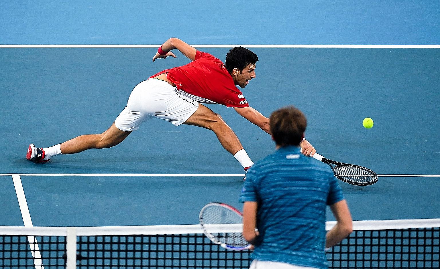 Serbia's Novak Djokovic stretching to return in his singles match against Russia's Daniil Medvedev, whom he beat 6-1, 5-7, 6-4 in Serbia's 3-0 victory. 