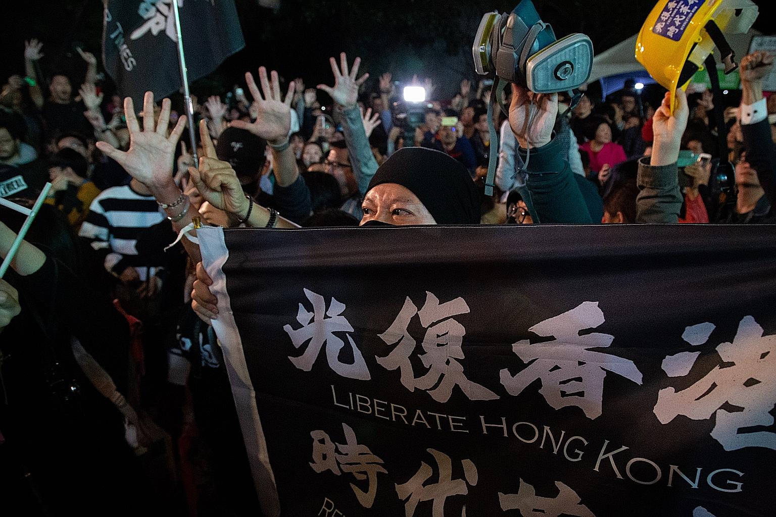 An attendee holding a flag in support of Hong Kong at a rally of Taiwan President Tsai Ing-wen's Democratic Progressive Party in Taipei on Saturday. PHOTO: BLOOMBERG