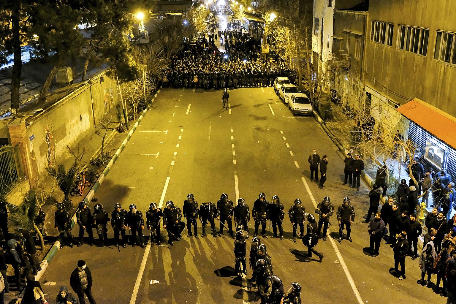Iranian police officers taking their positions last Saturday as protesters gathered in front of a university in Teheran to remember victims of a Ukraine International Airlines plane that was shot down by an Iranian missile last Wednesday, killing all