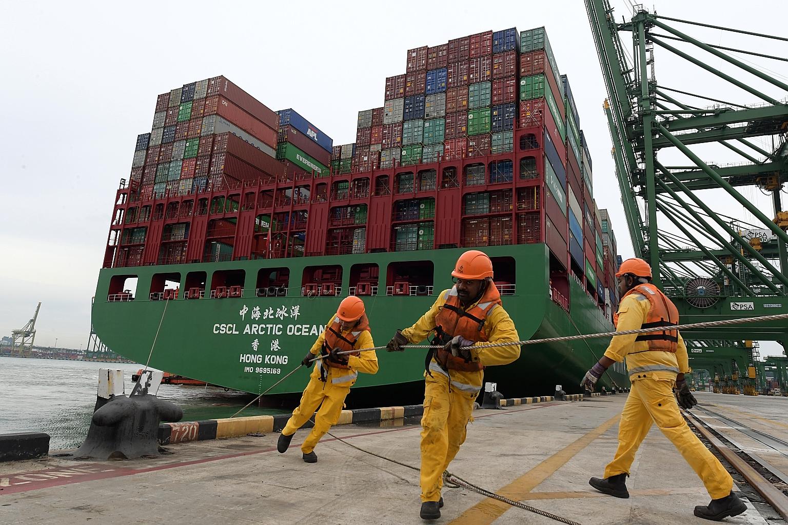 Workers at Pasir Panjang Terminal. Singapore's total cargo throughput fell slightly to 626.2 million tonnes but vessel arrival tonnage - a measure of the cargo-carrying capacity of ships - increased to 2.85 billion gross tonnes.