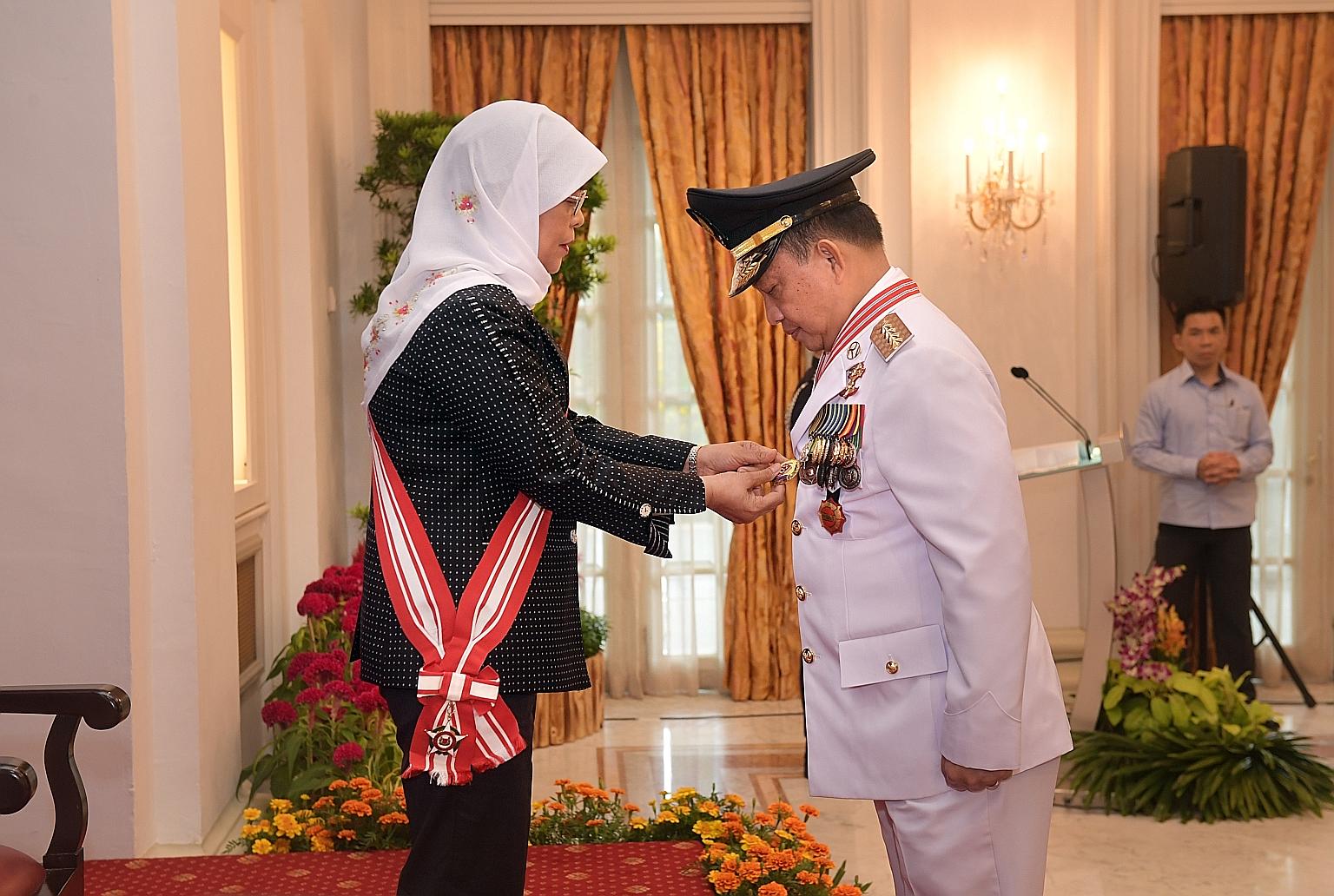 Indonesia's Minister of Home Affairs, Professor H. Muhammad Tito Karnavian, was conferred the Darjah Utama Bakti Cemerlang (Distinguished Service Order) by President Halimah Yacob at the Istana State Room yesterday. Prof Tito, who is also a retired p