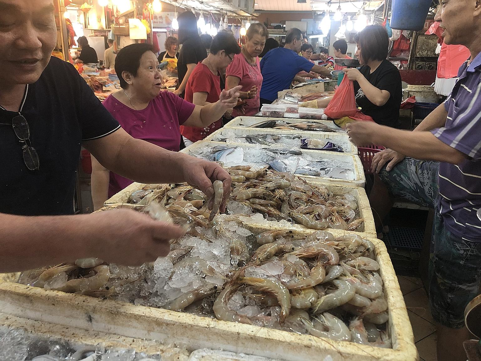 Mid-sized prawns were going for $10 to $16 a kilogram at Chong Pang market yesterday, thanks to better catches in Indonesia. This is well under the $40 a kilogram they have hit in past festive seasons. ST PHOTO: MELISSA HENG