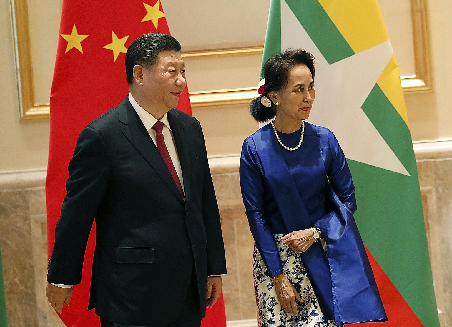 Myanmar State Counsellor Aung San Suu Kyi with Chinese President Xi Jinping at the presidential palace in Naypyitaw yesterday. Mr Xi is on a two-day visit to the country.