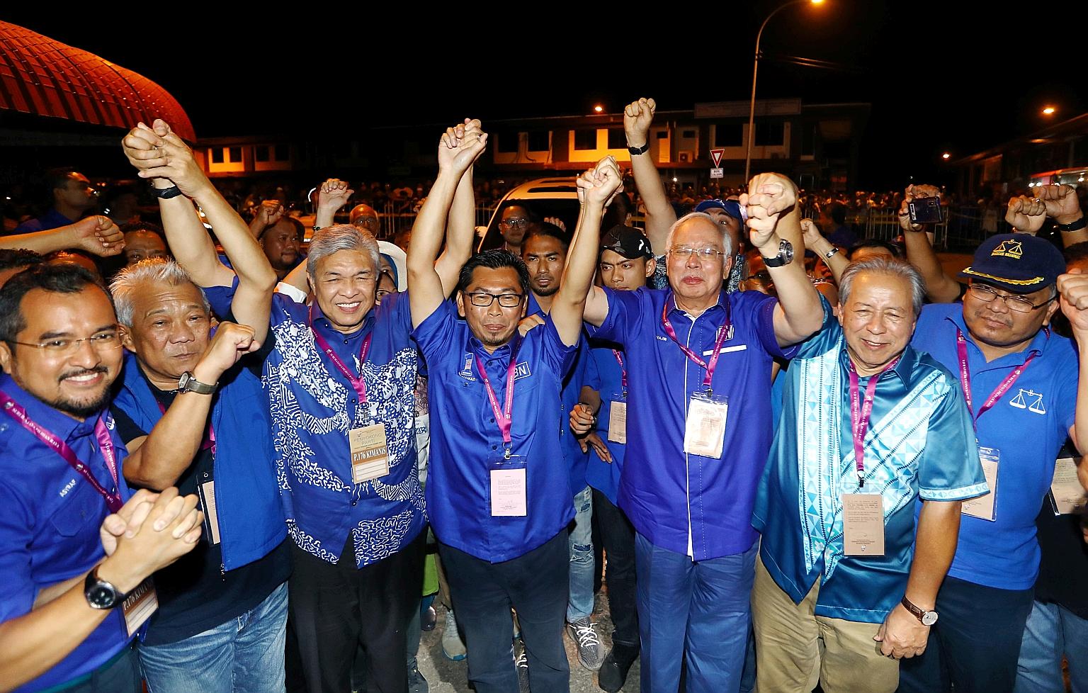 Barisan Nasional candidate Datuk Mohamad Alamin (centre) celebrating the opposition coalition's victory in Kimanis by-election in Sabah, flanked by former premier Najib Razak (right) and Umno president Ahmad Zahid Hamidi (left). PHOTO: THE STAR/ASIA 