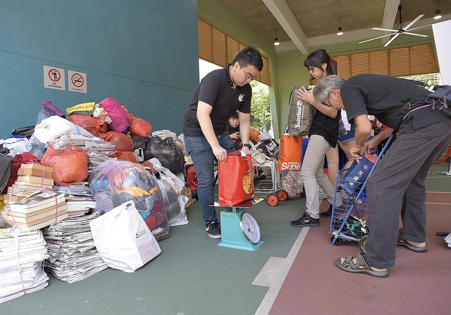 Residents of South West District swopping their recyclables for groceries or vouchers at Chua Chu Kang Community Club yesterday. The annual Clean Up South West! is in its 15th iteration this year.
