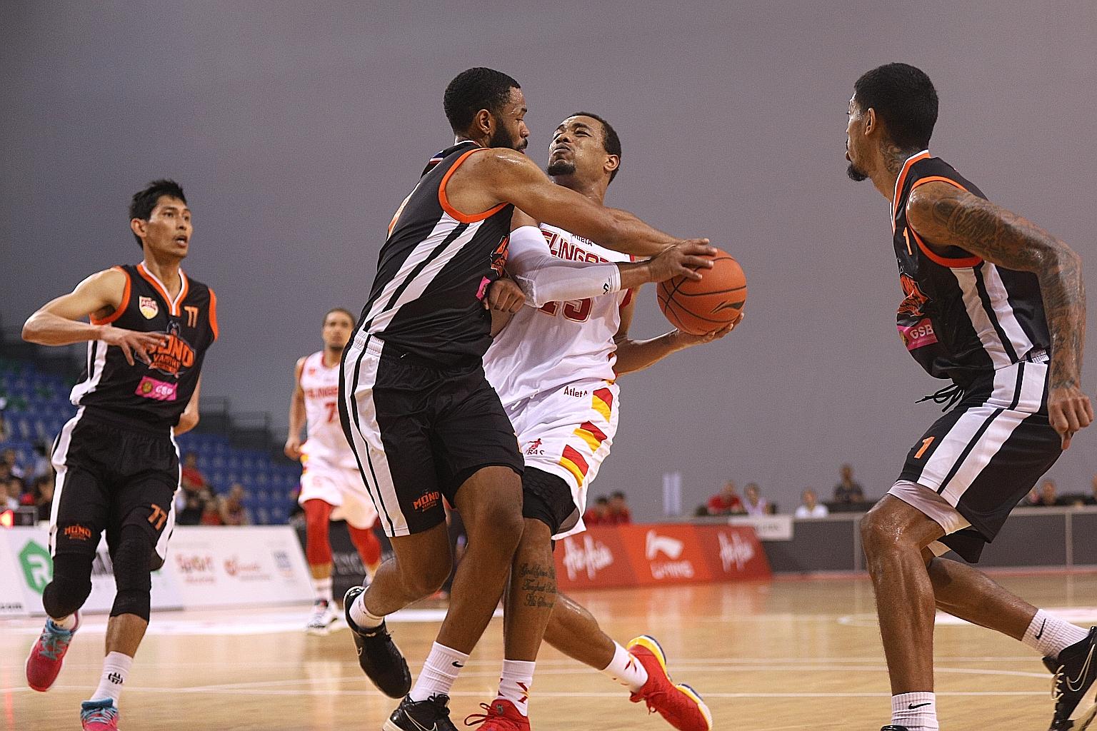 Slingers forward Xavier Alexander battling to retain possession during the ABL game against Mono Vampire at OCBC Arena yesterday. He took the final shot of the game and, while his two-pointer fell through the hoop, he did not get it off in time. 