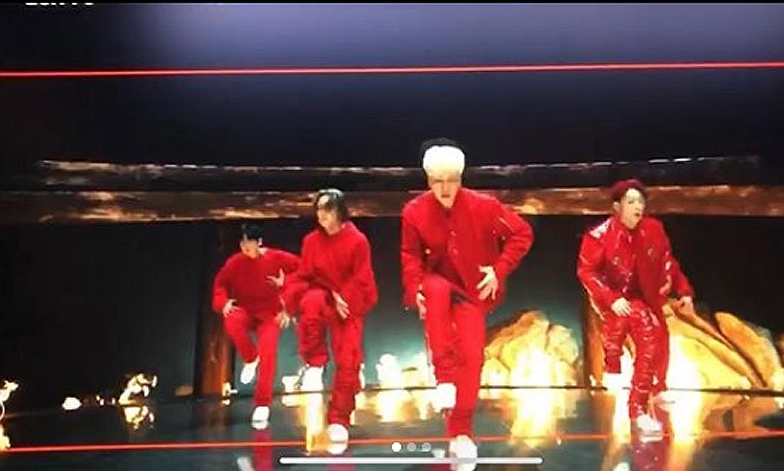 Pictures of iKON's new video show them in red outfits against a backdrop of fire, perhaps hinting at the trials they have faced in the last half year.