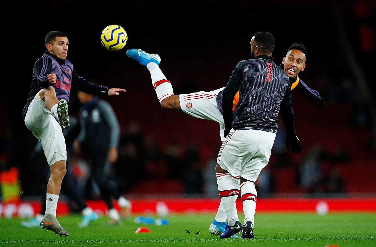 Arsenal's Pierre-Emerick Aubameyang (right), during a warmup session with Lucas Torreira and Alexandre Lacazette before a match against Brighton last month, will miss the clash today owing to a suspension. The Gabon striker is the club's top scorer w