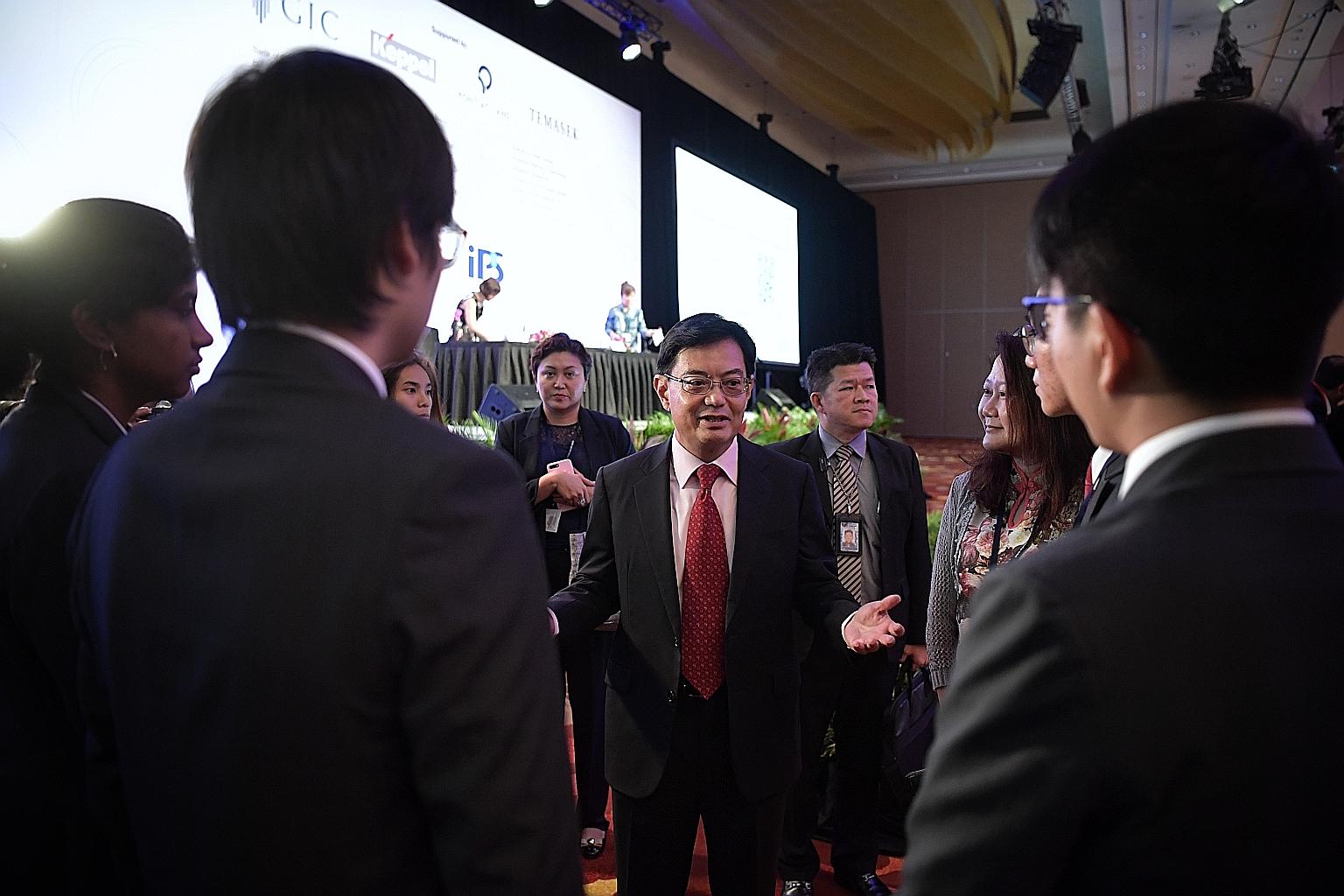 Deputy Prime Minister Heng Swee Keat meeting Temasek Polytechnic students at the conference yesterday, where he spoke of the need to maintain unity. ST PHOTO: KUA CHEE SIONG