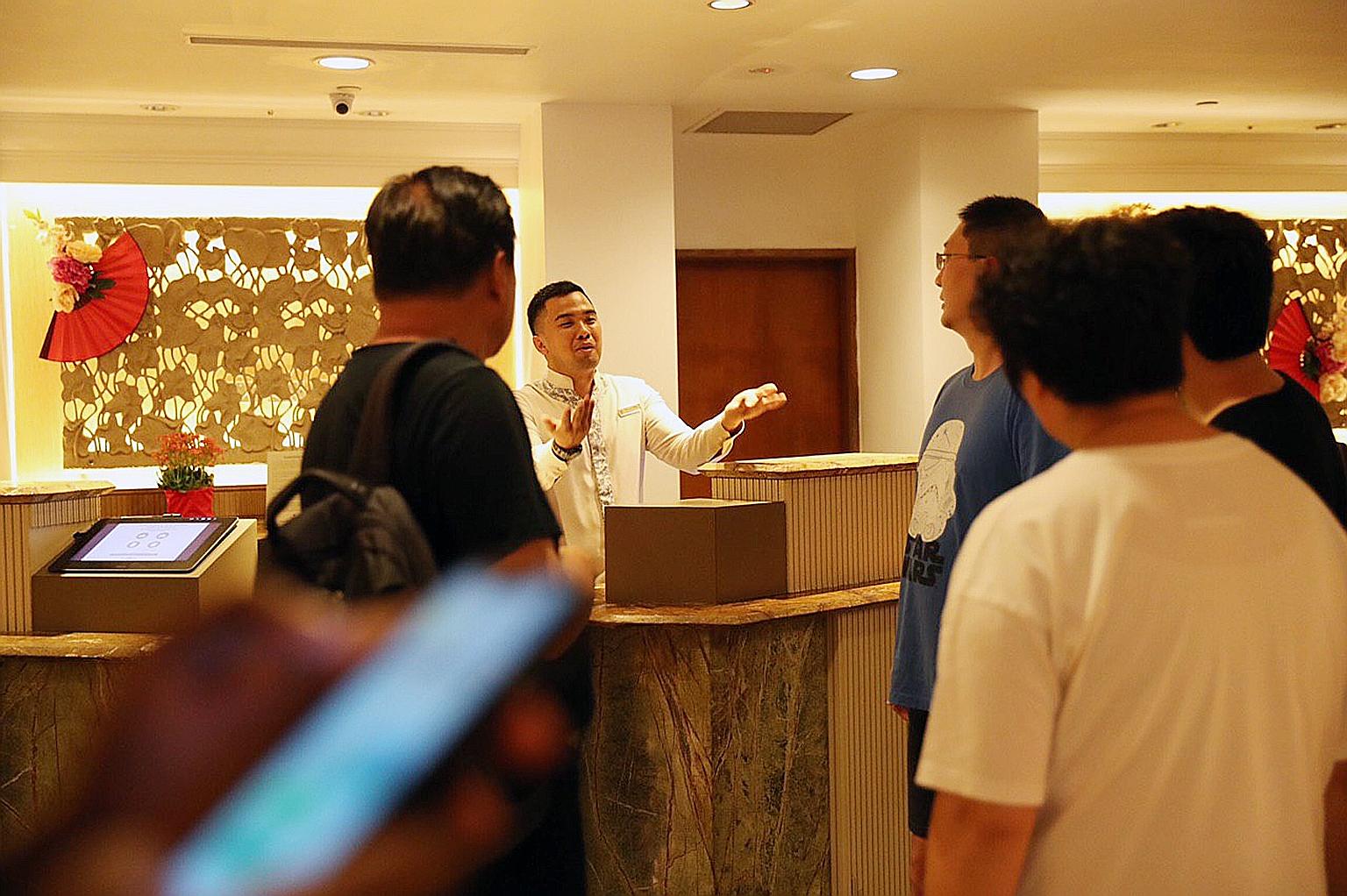 Mr Kelvin Yu (in blue T-shirt), who was staying at Shangri-La's Rasa Sentosa Resort & Spa with his family, asking a hotel employee yesterday which room the infected guest had stayed in. ST PHOTO: TIMOTHY DAVID