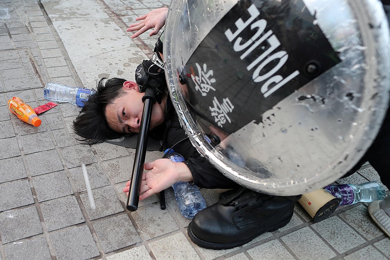 A protester in Hong Kong under arrest. Of the more than 7,000 protesters held, only 1,092 have been charged and just 12 people have been sentenced. PHOTO: REUTERS