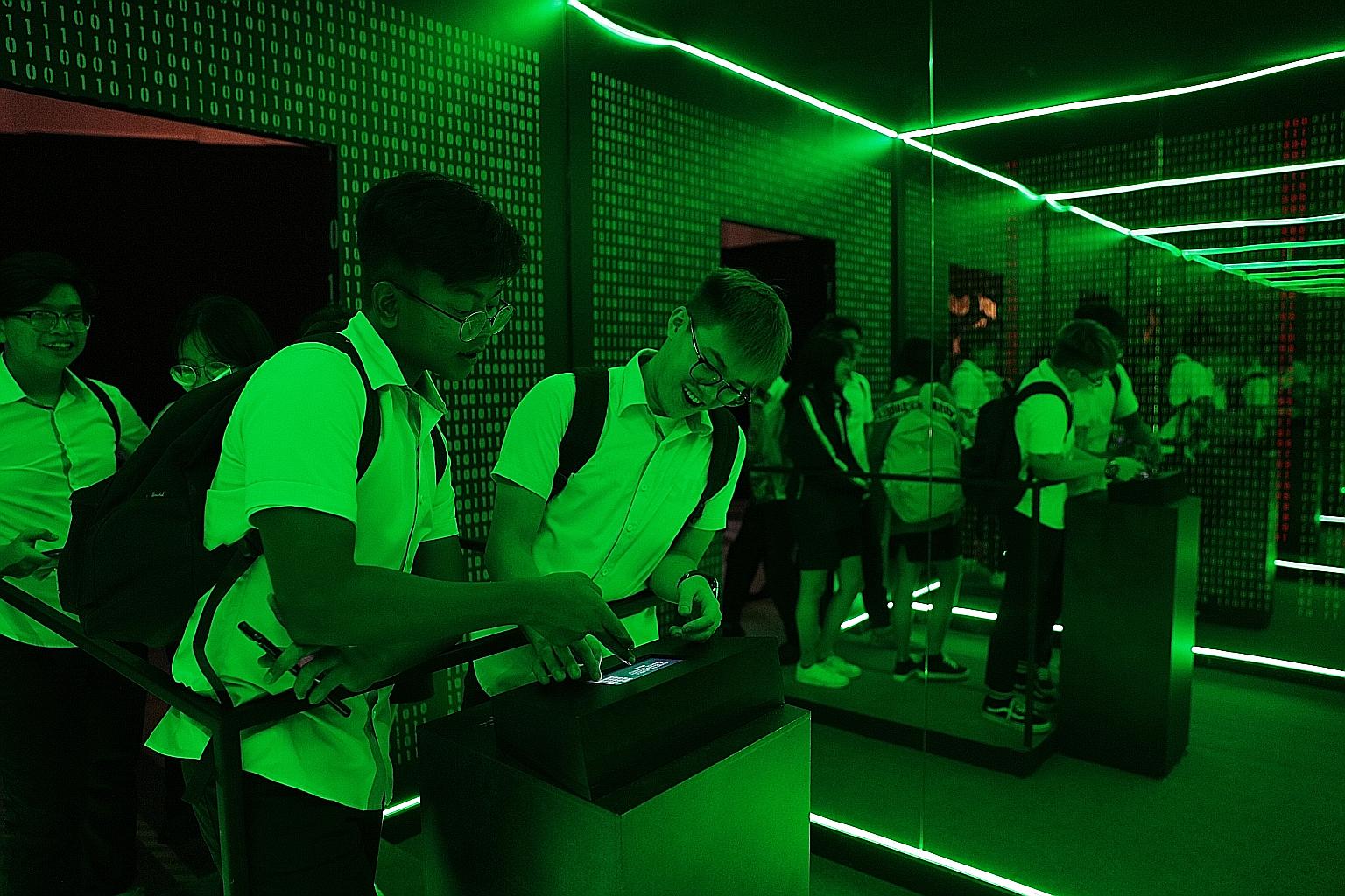 Students from ITE College Central trying to solve a puzzle that requires them to find clues from the special exhibition - titled Will You Do You? - at the Singapore Discovery Centre on Tuesday. The exhibition is among the activities that the centre h