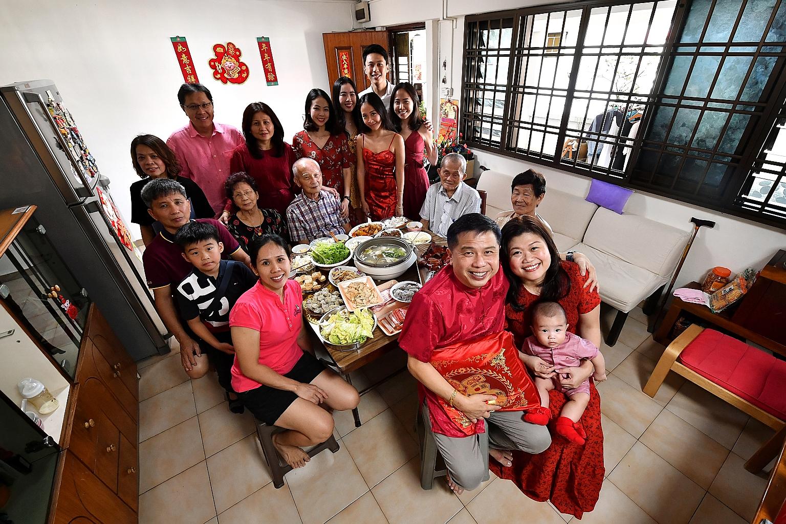 Ms Jaslyn Aw, her husband Martin Peh and their six-month-old son Finn Sage all set for their reunion dinner with their family at Mr Peh's parents' flat in Tampines on the eve of Chinese New Year yesterday. ST PHOTO: LIM YAOHUI