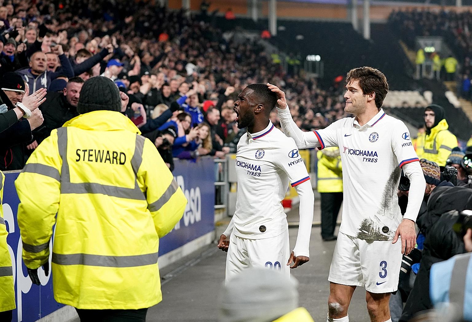 Fikayo Tomori celebrating with fans after putting Chelsea 2-0 up against Hull in the FA Cup, as Marcus Alonso joins in. The Blues won 2-1. 