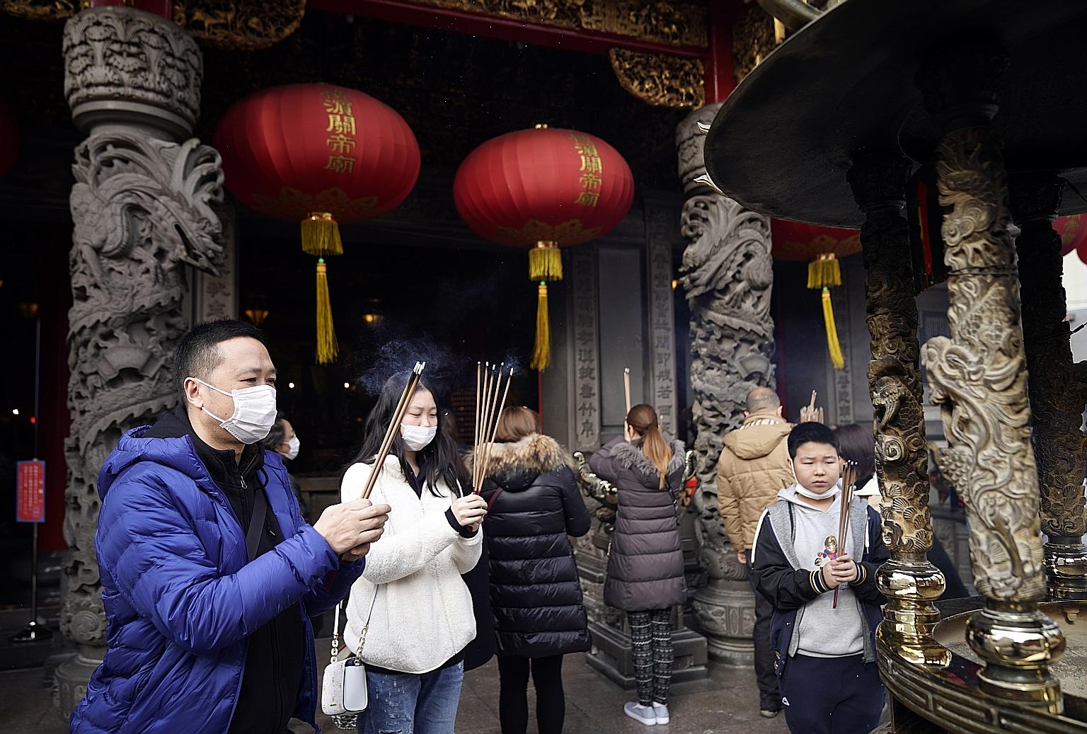 Visitors offering prayers at the Kanteibyo temple as part of Chinese New Year celebrations in Yokohama's Chinatown, near Tokyo, on Saturday.