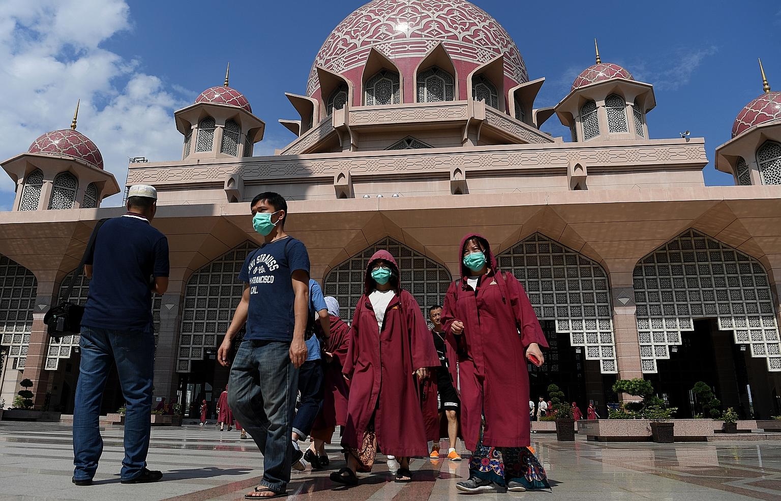 Visitors outside the Putra Mosque in Putrajaya on Sunday. The Malaysian government closed the mosque to visitors starting from Sunday, following the coronavirus outbreak. It has also halted entry to the country for Chinese travellers from Hubei provi