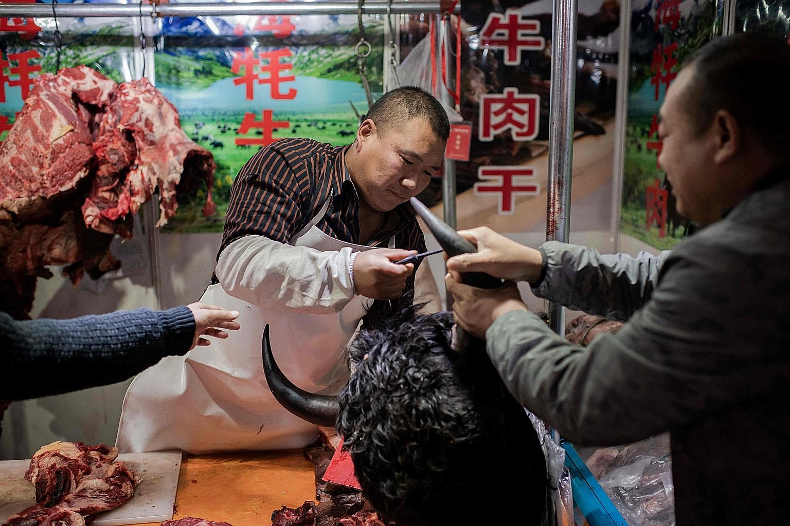 A butcher selling yak meat at a market in Beijing earlier this month. China has in recent months and years cracked down on the illegal wildlife trade. It also banned wildlife in markets in 2003 in the wake of Sars - as it has now. But the ban was rel
