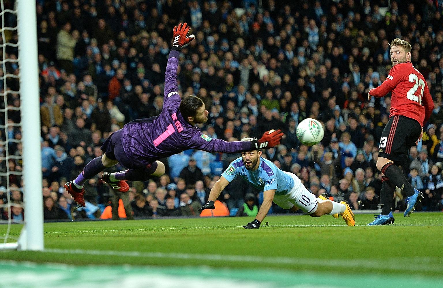 United goalkeeper David de Gea saving City striker Sergio Aguero's diving header during their League Cup semi-final second-leg match. City took 13 shots on Wednesday, with man-of-the-match de Gea saving all four that were on target. PHOTO: EPA-EFE