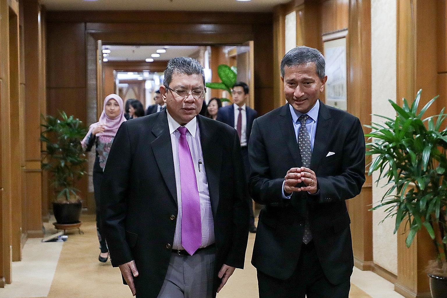 Foreign Minister Vivian Balakrishnan with his Malaysian counterpart Saifuddin Abdullah in Putrajaya yesterday.