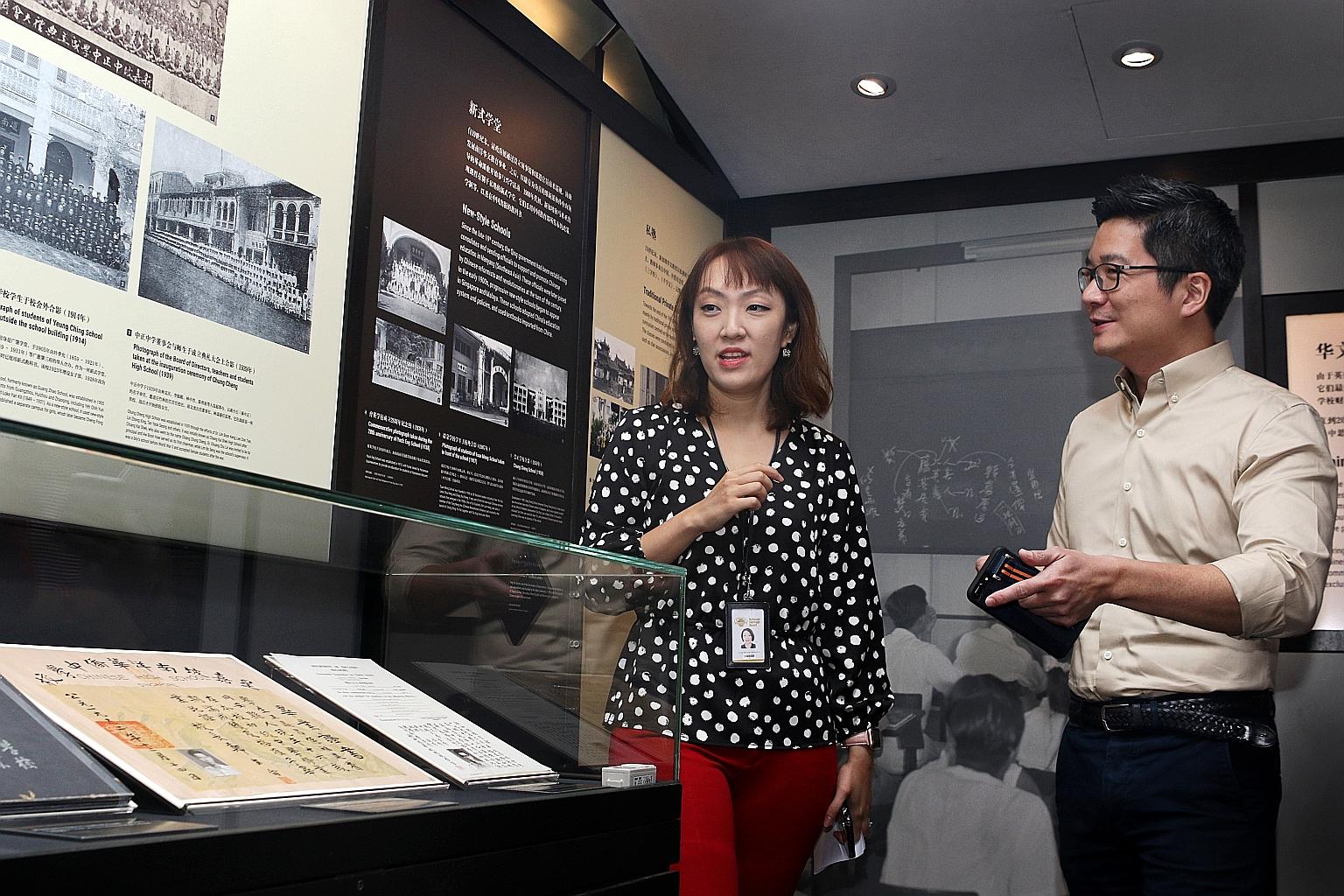 Ms Jermaine Chua, curator of Sun Yat Sen Nanyang Memorial Hall, and Mr Alvin Tan, deputy chief executive for policy and community at the National Heritage Board, introducing an exhibit at Gallery 4 - Chinese Business Pioneers yesterday. The revamped