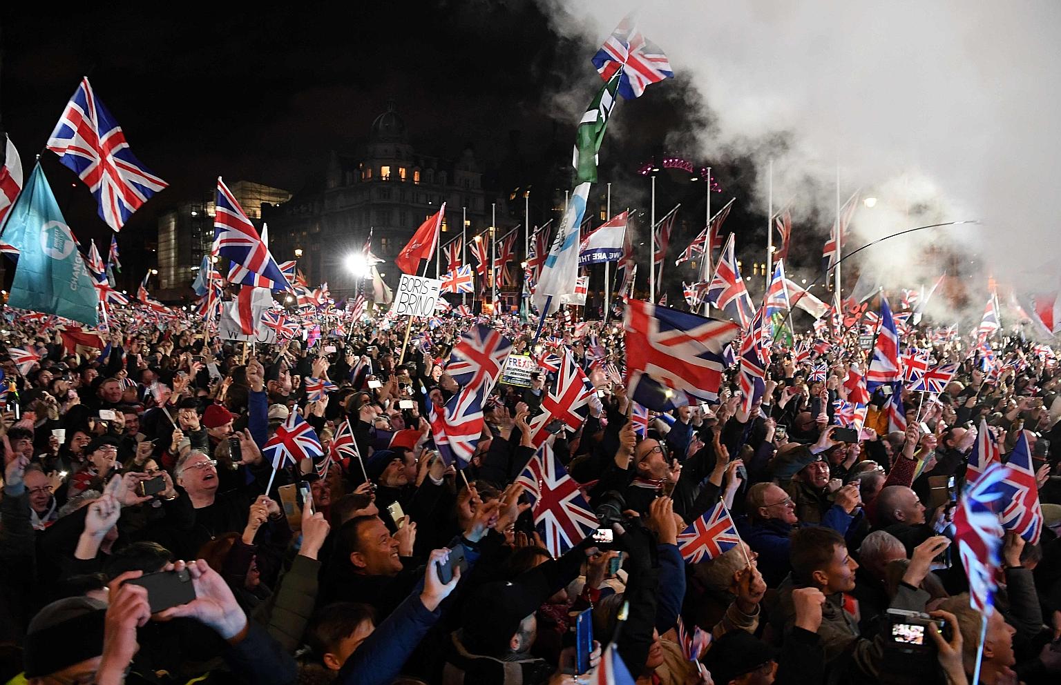 Brexit supporters waving Union Jacks in Parliament Square on Friday night to celebrate Britain's departure from the European Union after 47 years. Proponents of Brexit hope that it will herald reforms to reshape Britain and propel it ahead of its Eur