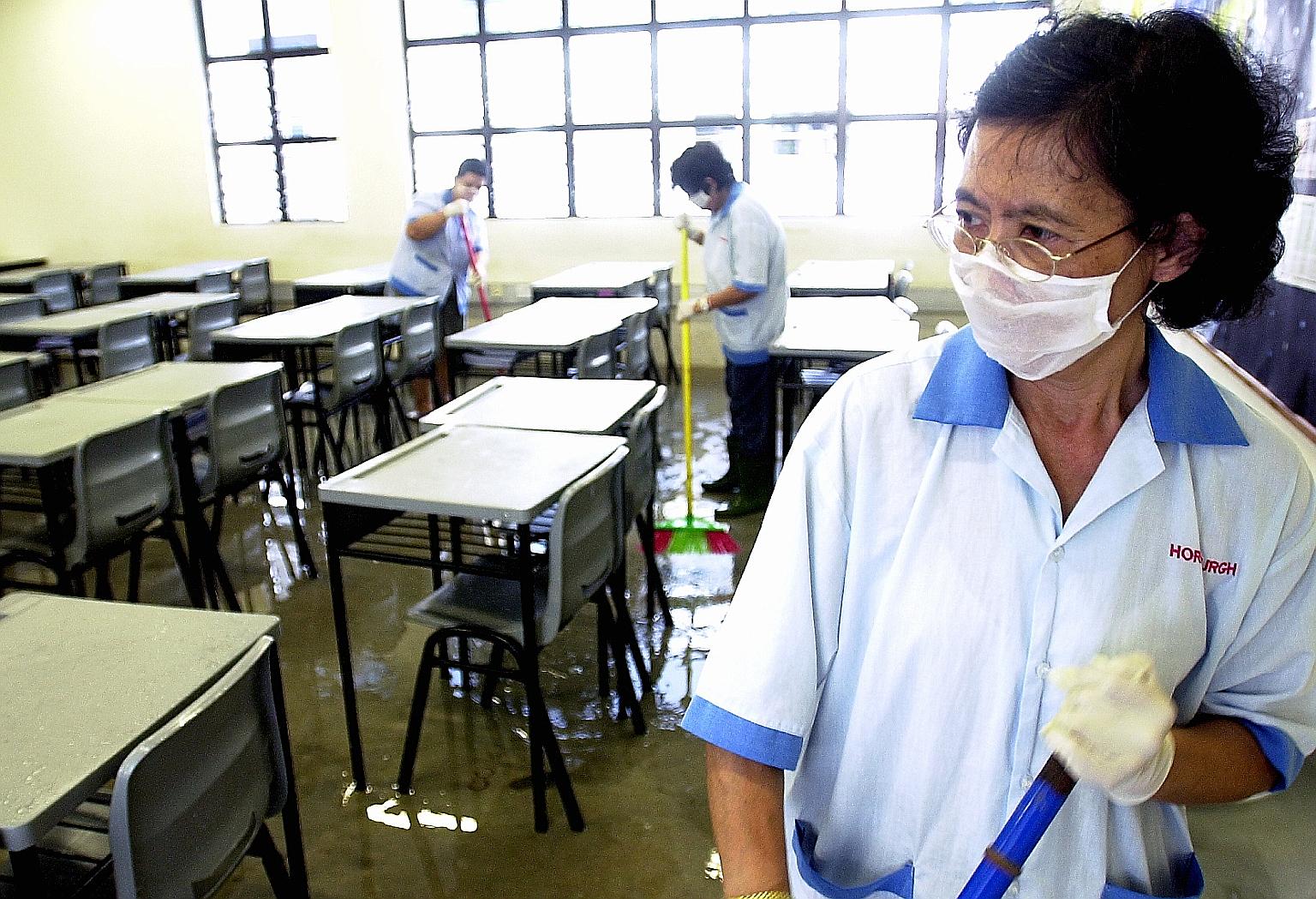 Cleaners disinfecting the floors of all the classrooms at Bowen Secondary School in an attempt to reduce the risk of infection during the Sars outbreak in Singapore, which lasted from March to July 2003.
