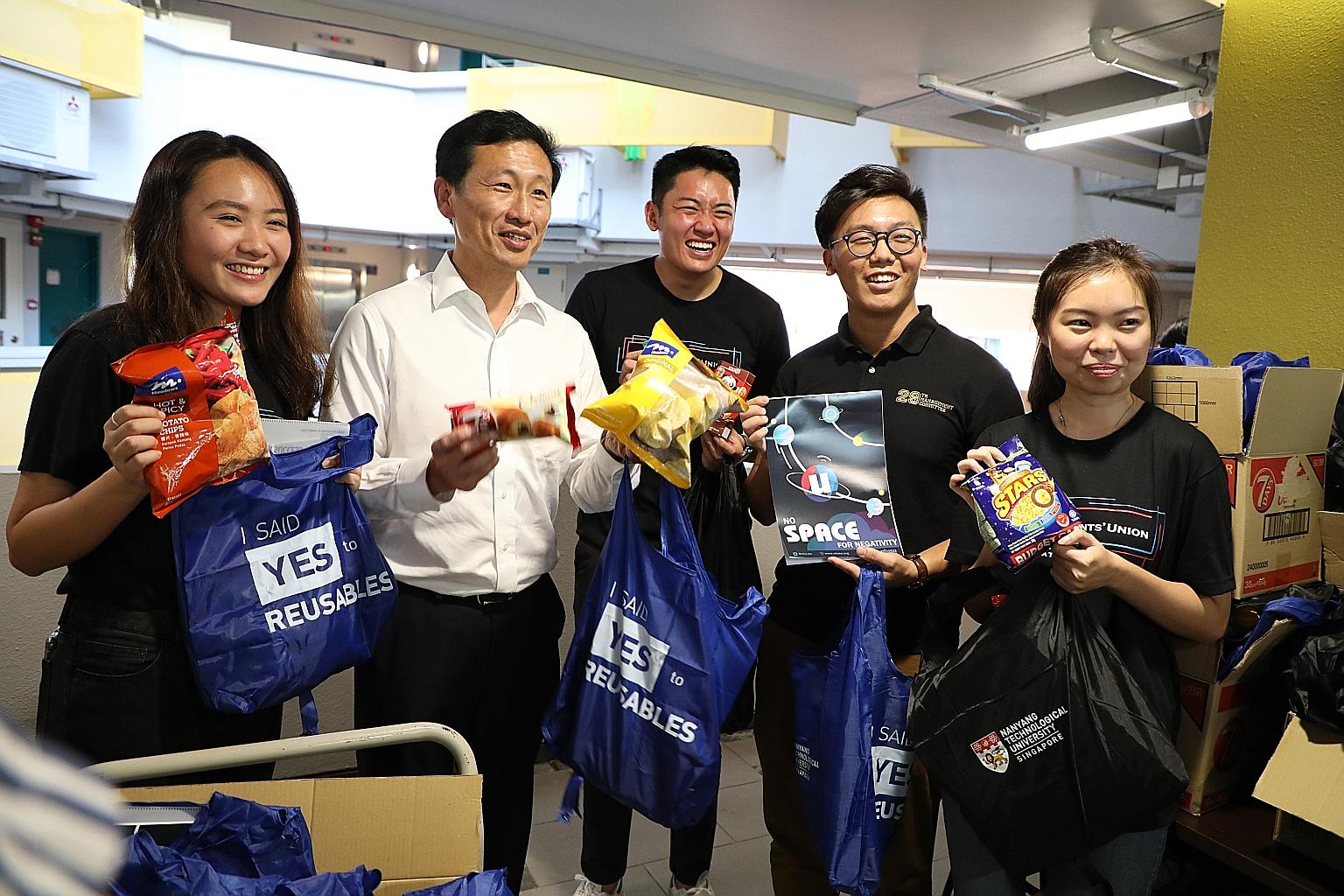 Education Minister Ong Ye Kung with student volunteers from Nanyang Technological University yesterday. He visited students on leave of absence at NTU and National University of Singapore's quarantine facilities, and helped deliver welfare and food p